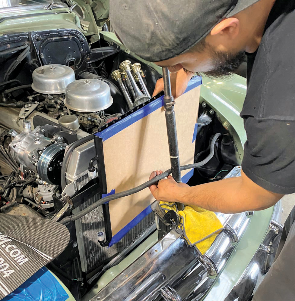 14 Jimenez Bros slides the condenser in place to test-fit on the brackets
