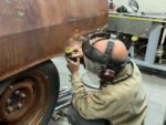 03 Geoff Jones using a pneumatic die grinder with a thin cut off wheel to cut away rusty metal