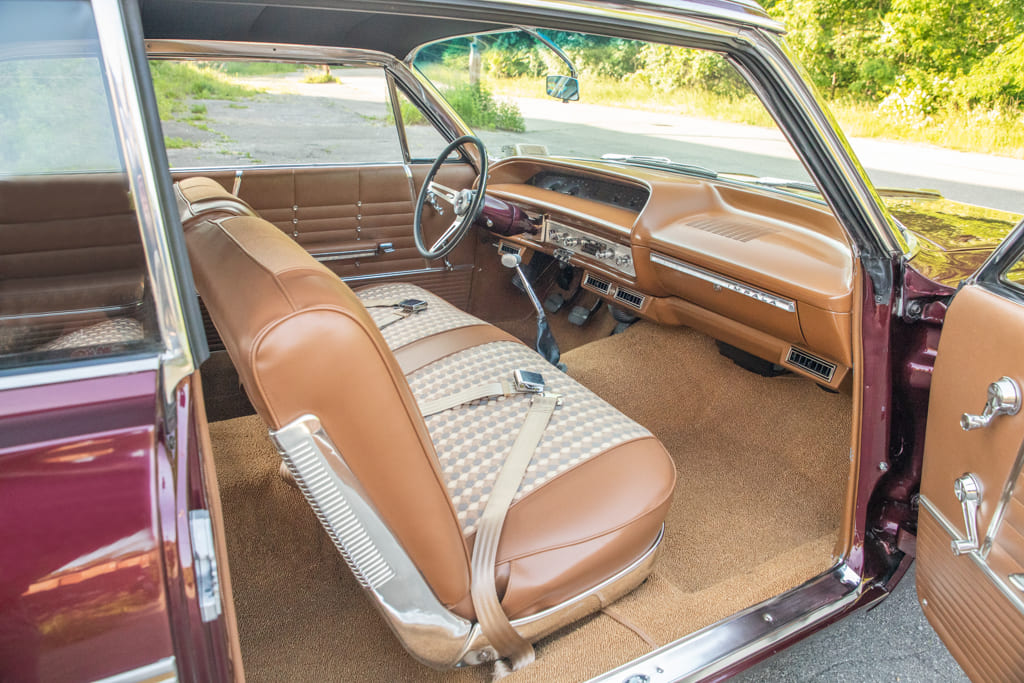 012 Vintage car interior with tan bench seats and period correct styling