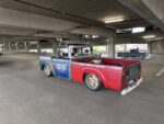 26 Rustic multi colored Chevrolet pickup truck in motion featuring vintage advertising