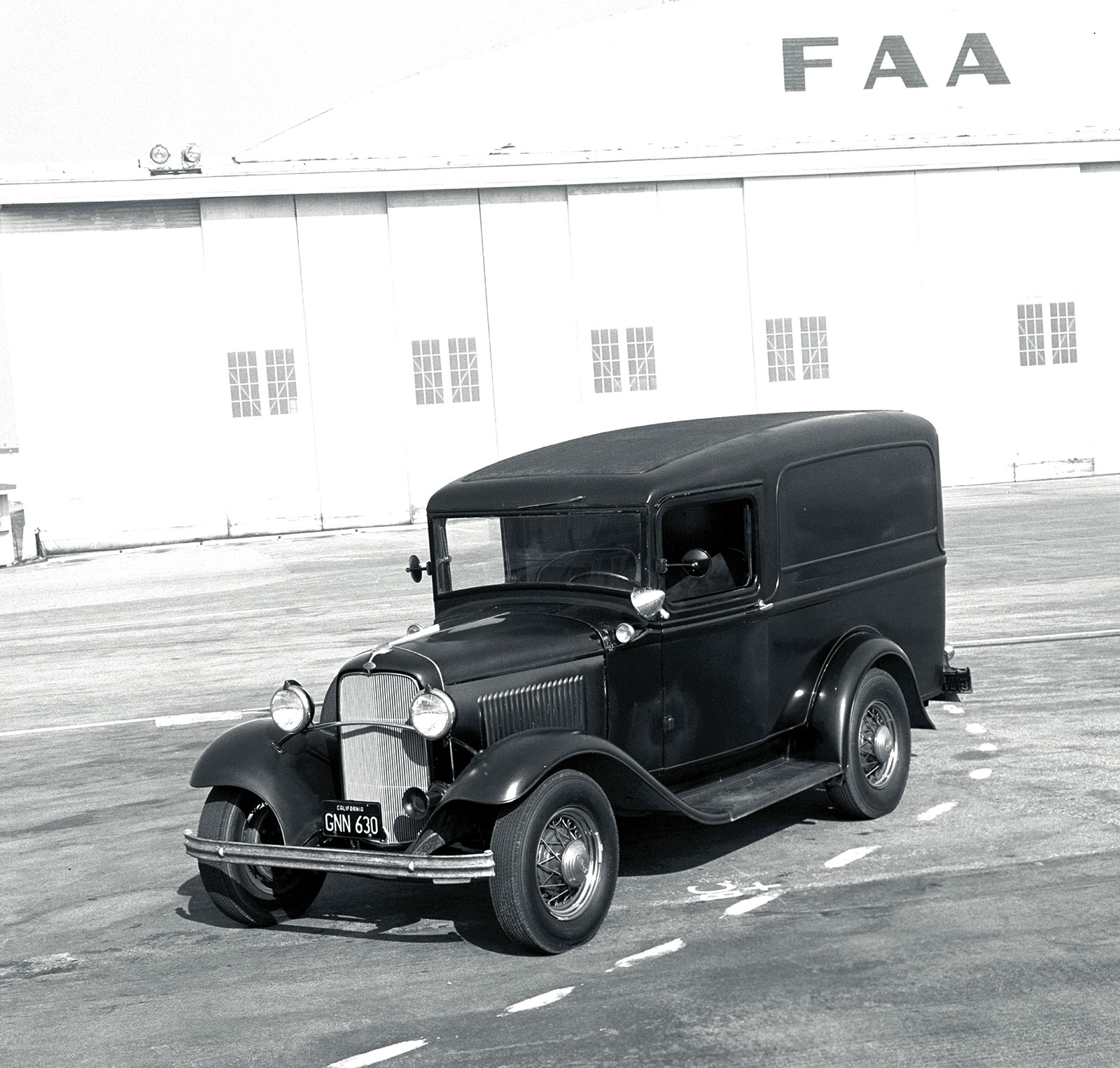01 Vintage 1932 Ford panel truck photographed by Tex Smith in front of Howard Hughes Santa Monica airport hangar showcasing the history of classic automobiles