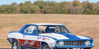 002 Side profile of the 1969 COPO Camaro drag car showcasing its sponsor stickers and drag racing wheels