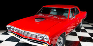 01 A red 1967 Chevelle with a glossy finish on a black and white checkered floor