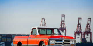 05 1971 red GMC truck in front of shipping containers