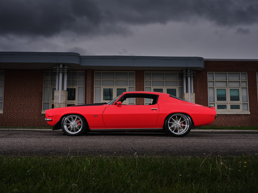 007 Side profile of the 1970 Camaro Z28 against a brick building backdrop