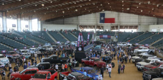 01 Large indoor truck show with numerous customized trucks on display and attendees exploring