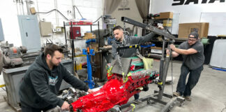 01 Team installing a red engine on the 66 GMC truck frame