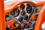 016 Close up of the dashboard in a 1955 Chevy Bel Air showcasing modern gauges and chrome accents