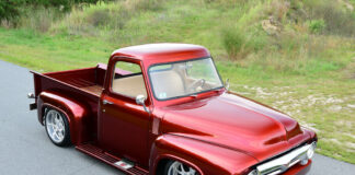 02 1953 Ford truck side view sleek red finish chrome accents low stance