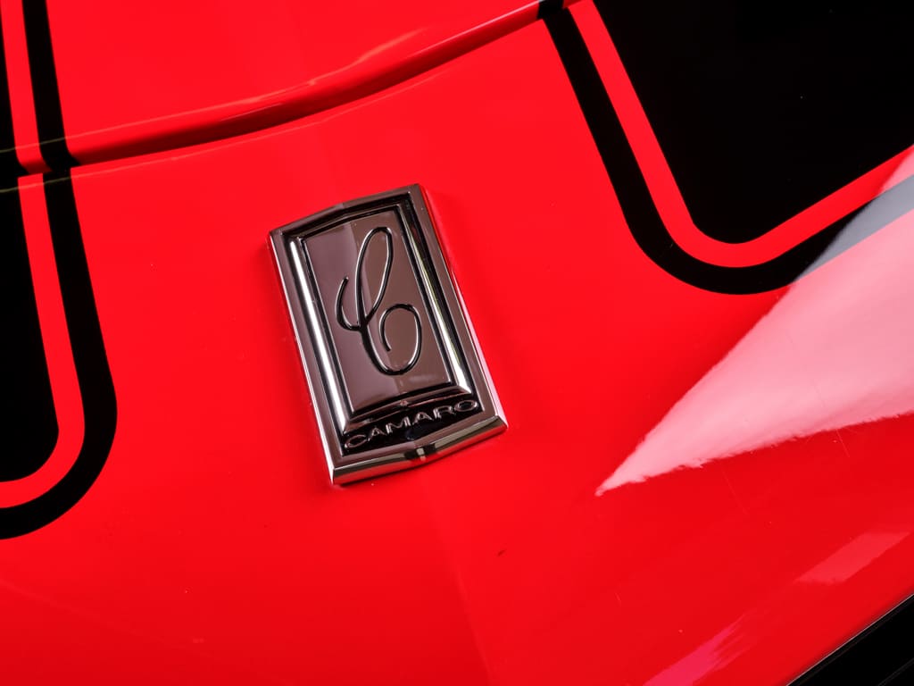 020 Hood emblem on a red 1970 Camaro with black racing stripes