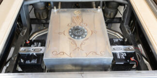 001 Custom fuel tank with intricate engravings in the bed of a truck chassis