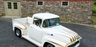 001 Custom white and gold Ford F100 with unique striping parked in front of a stone building
