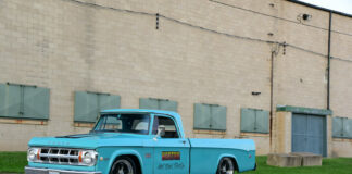001 Turquoise 1969 Dodge D200 parked beside a brick building with Horton Hot Rod Parts decal
