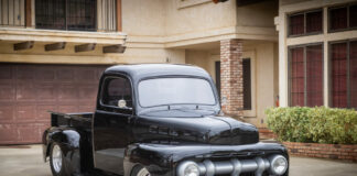 01 Custom 1951 Ford F 1 pickup in black with a lowered stance and sleek front grille