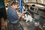 What You Need to Know About Installing Steering Components 01 Installing steering column in 1952 Chevy pickup cab with a dog nearby