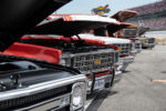 01 A lineup of Chevrolet trucks from the 1973 1987 era at a car show with hoods open for display
