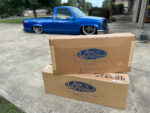 01 Two Vintage Air boxes on display in front of a customized blue 1990s Chevrolet CK 1500