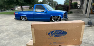 01 Two Vintage Air boxes on display in front of a customized blue 1990s Chevrolet CK 1500