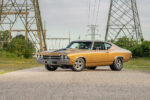 001 1969 Chevrolet Chevelle SS in gold with black stripes parked in front of power lines