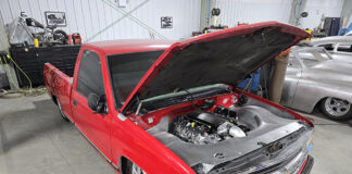 01 Red OBS with open hood showcasing engine modifications in a garage