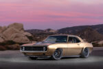 001 Pro touring style 1969 Chevy Camaro in gold with custom black wheels and lowered stance in desert setting