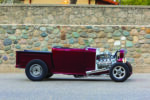 01 1932 Ford Roadster pickup with a sleek maroon finish and custom chrome exhaust system