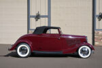 01 1933 Ford Cabriolet side profile with maroon paint whitewall tires chrome hubcaps and black convertible top