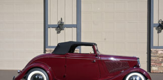 01 1933 Ford Cabriolet side profile with maroon paint whitewall tires chrome hubcaps and black convertible top