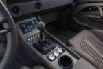 012 Center console of 1969 Camaro with modern touchscreen display and manual gear shifter
