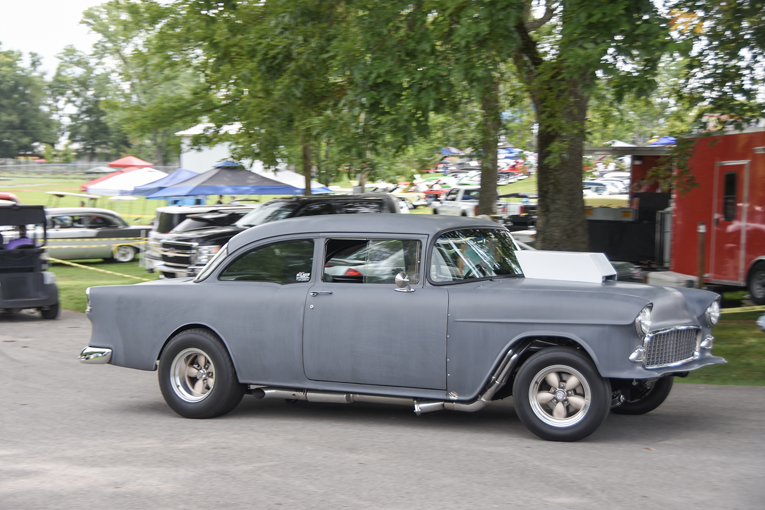 02 1955 Chevrolet 210 in primer gray with a drag racing setup including side exhaust and classic American Racing wheels