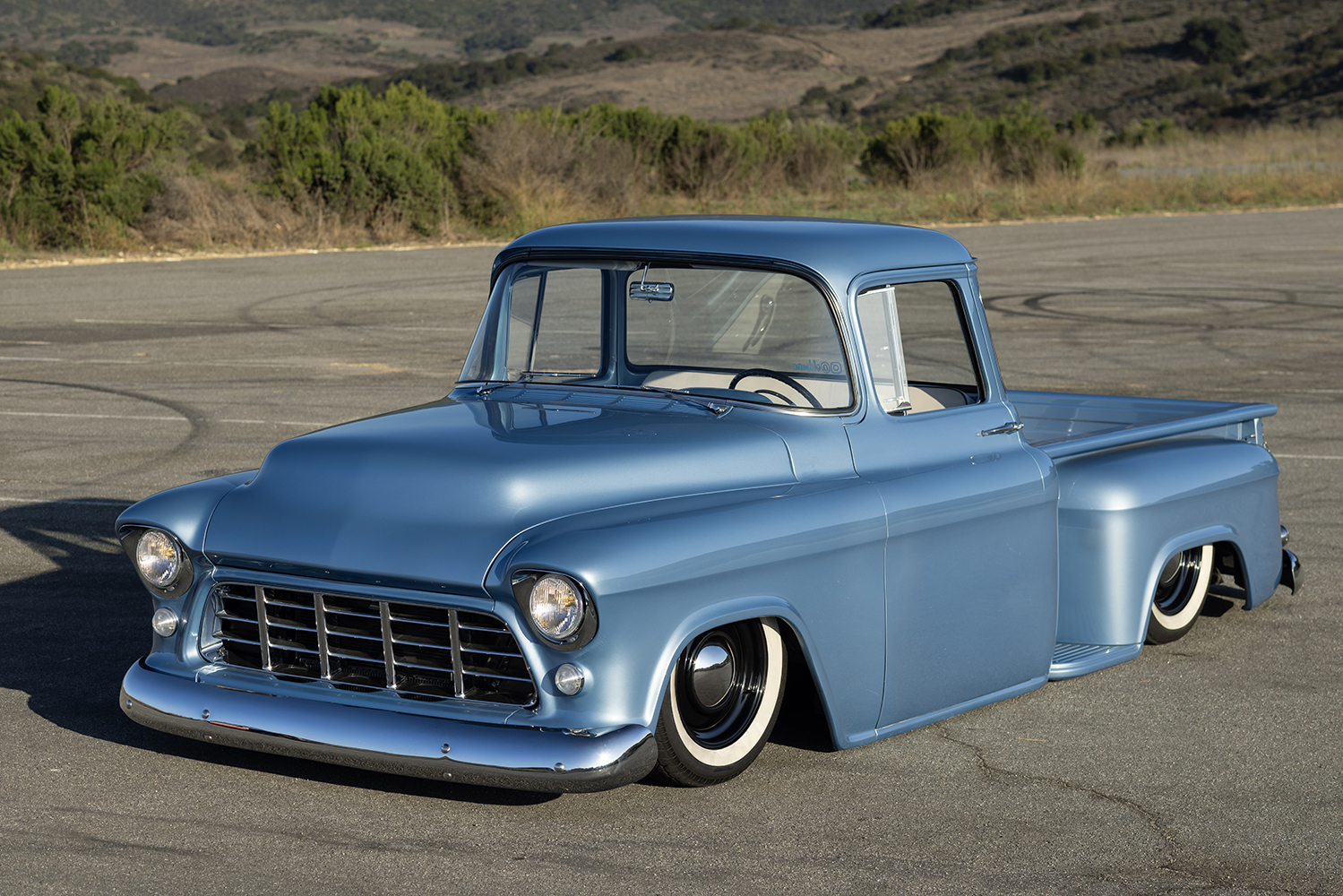 02 1955 Chevy truck side view sleek lines with whitewall tires for a vintage look