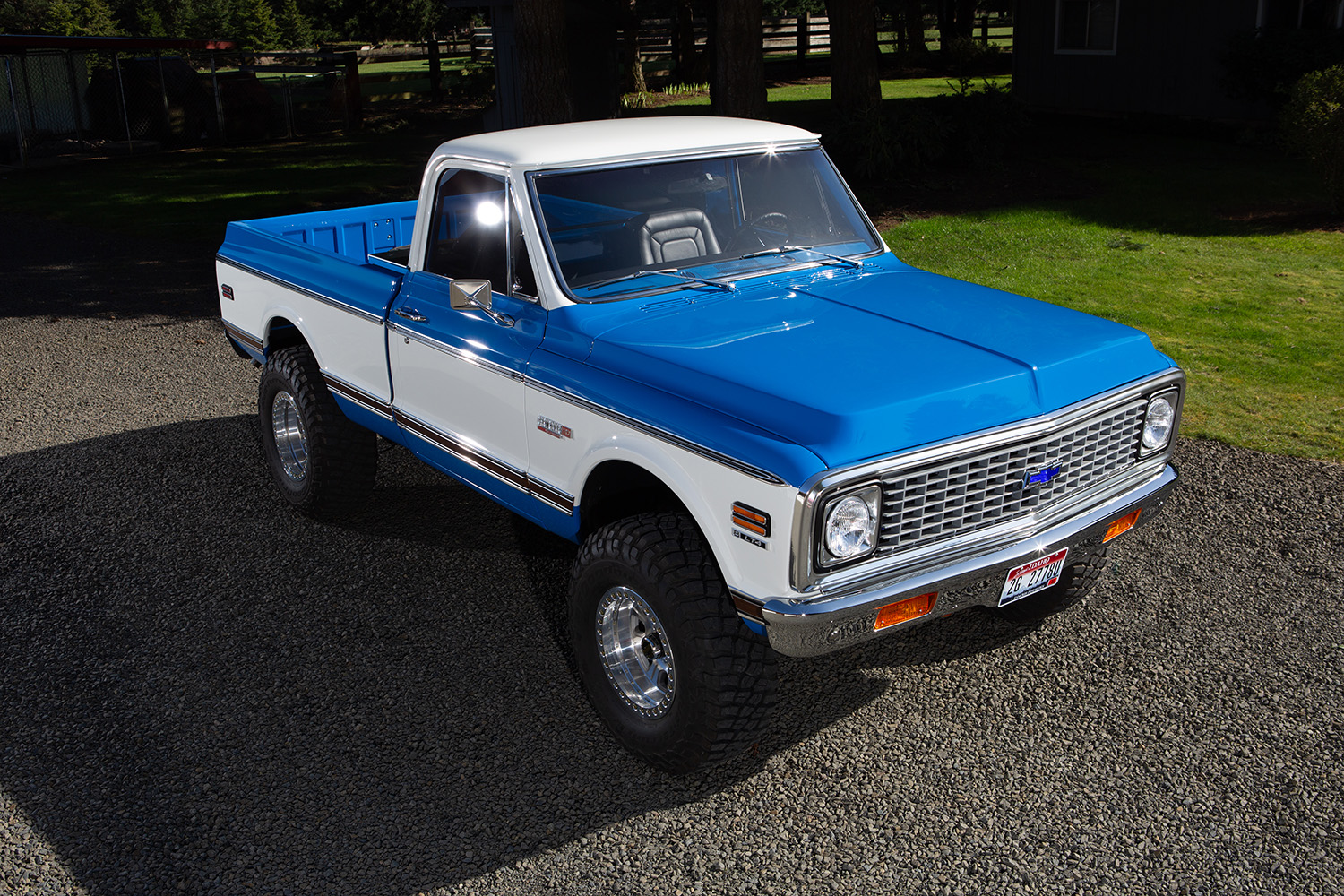 02 Front view of 1972 Chevy K10 showcasing classic chrome grille dual headlights and vibrant blue and white color scheme