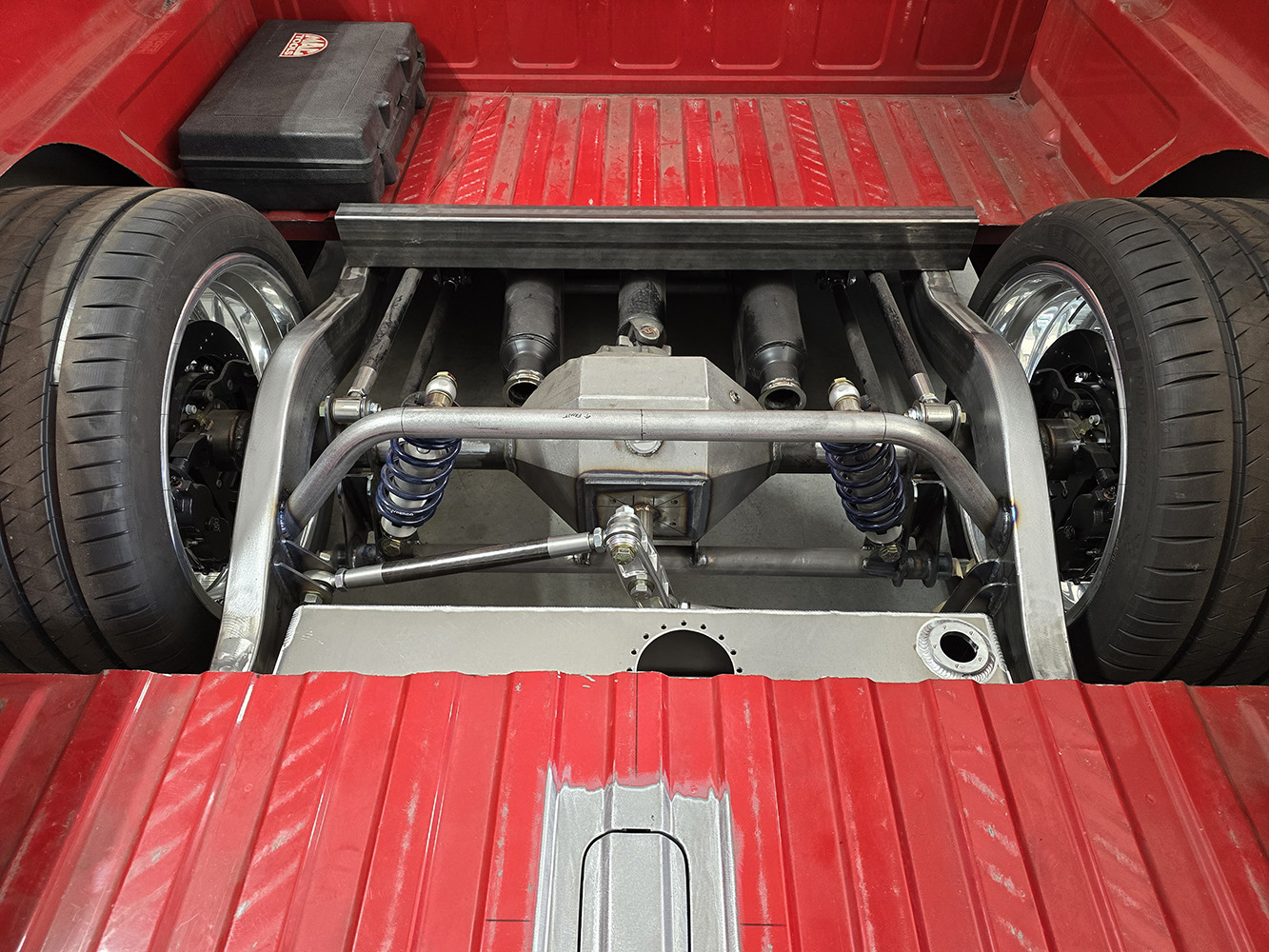 02 Rear suspension with coilovers and custom metalwork exposed in Chevy OBS truck bed