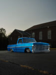 03 Front view of lowered 1969 Ford F 100 showcasing chrome bumper and minimalist custom headlight design