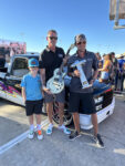 03 Winners holding a trophy and guitar next to their award winning 1988 98 Chevrolet truck