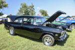 04 1955 Chevrolet Bel Air in black with chrome wheels and “409” badging hood open to showcase performance modifications