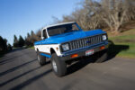 04 1972 Chevy K10 action shot driving on country road blue and white paint and raised suspension