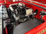06 Engine bay of GMC K2500 featuring modern LS engine with dual PSC reservoirs and polished intake
