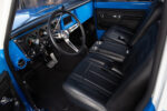 07 Close up of 1972 Chevy K10 center console with black leather upholstery and stainless steel cup holders