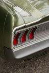 11 1967 Ford Mustang Fastback rear taillight close up with signature tri bar red lens and chrome trim detail