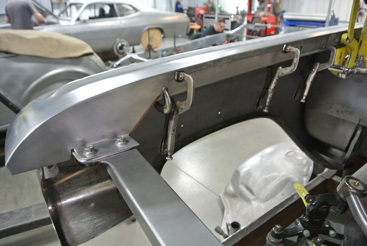 11 Custom inner fender fabrication on the 1959 Chevy with C clamps holding freshly mounted panel