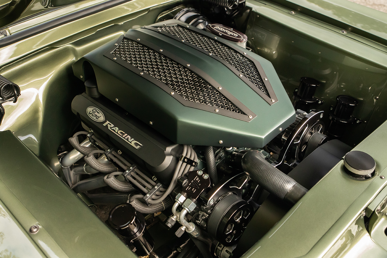 12 1967 Ford Mustang Fastback engine bay featuring custom Ford Racing intake and braided exhaust headers