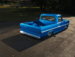 12 Angled shot of 1969 Ford F 100 bed featuring a seamless smooth custom paint finish in metallic blue