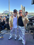 12 Two participants in matching gold and silver outfits adding flair at the Triple Crown Truck Show