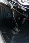 13 1932 Ford Coupe's sleek shifter and chrome detailing on custom floor console