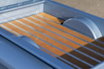 13 1955 Chevy truck bed featuring wood planks and polished metal accents
