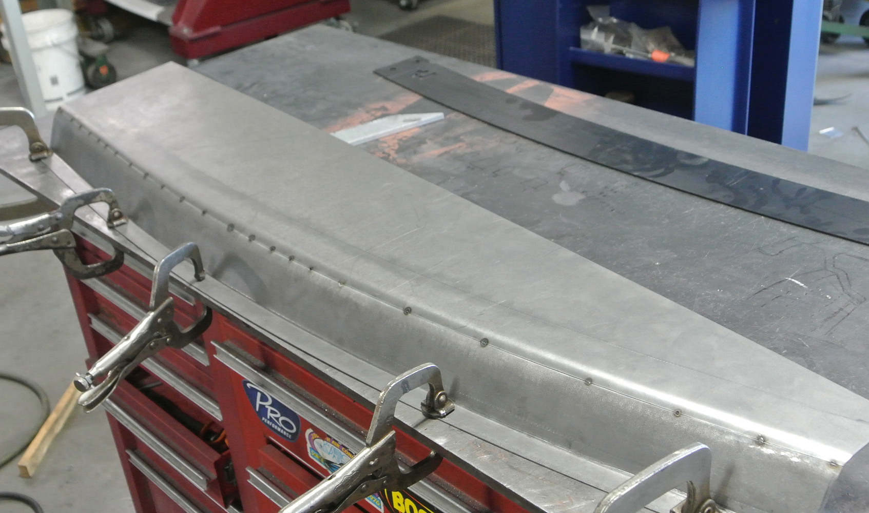 13 Hand formed metal panel secured with clamps prepared for welding and fitment