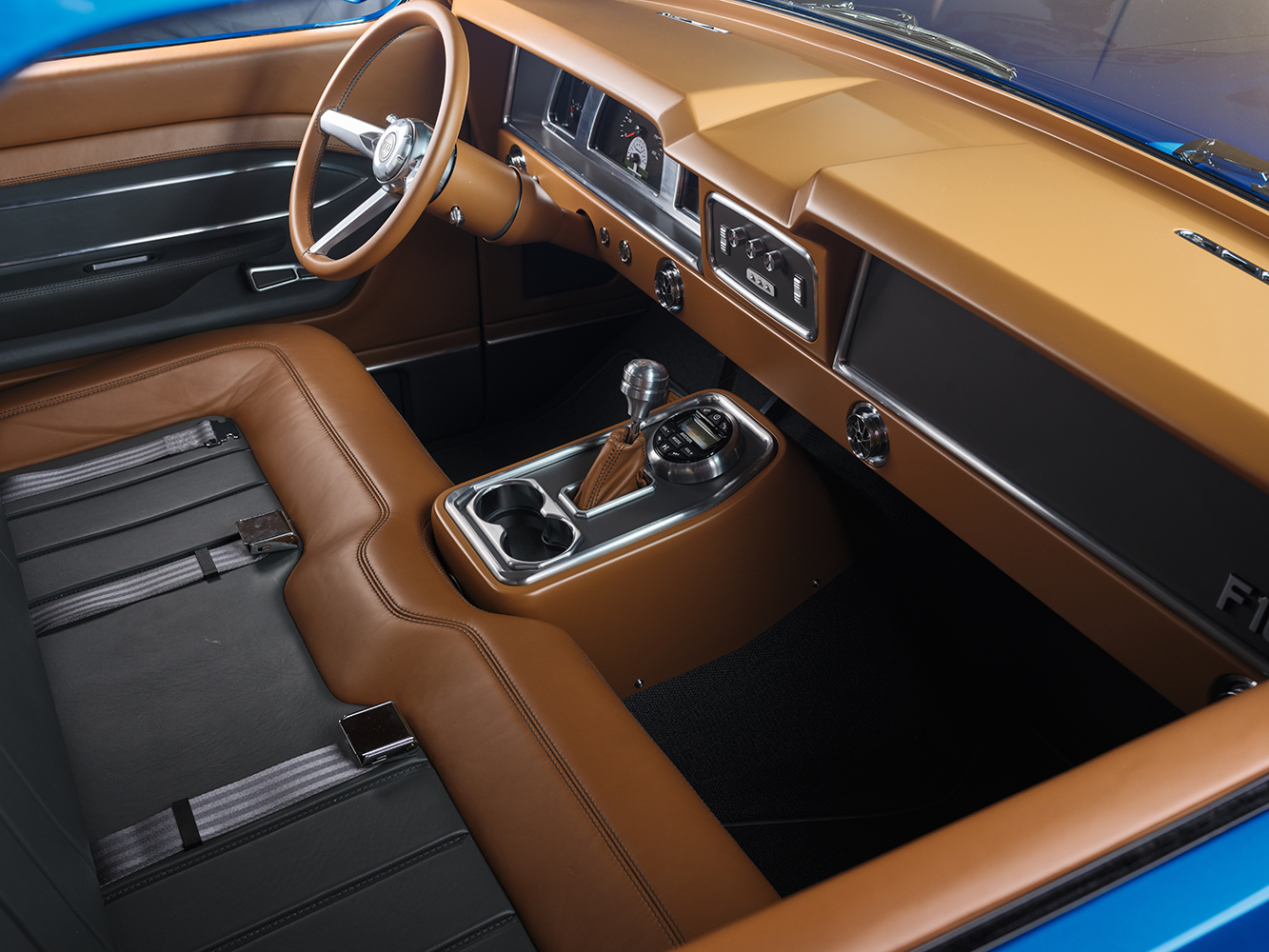 15 Interior of 1969 Ford F 100 with tan leather wrapped dashboard and steering wheel showcasing a modern retro design