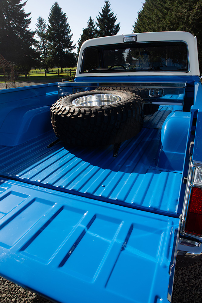15 Truck bed view of Chevy K10 with spare tire mounted highlighting blue paint and clean bedliner finish