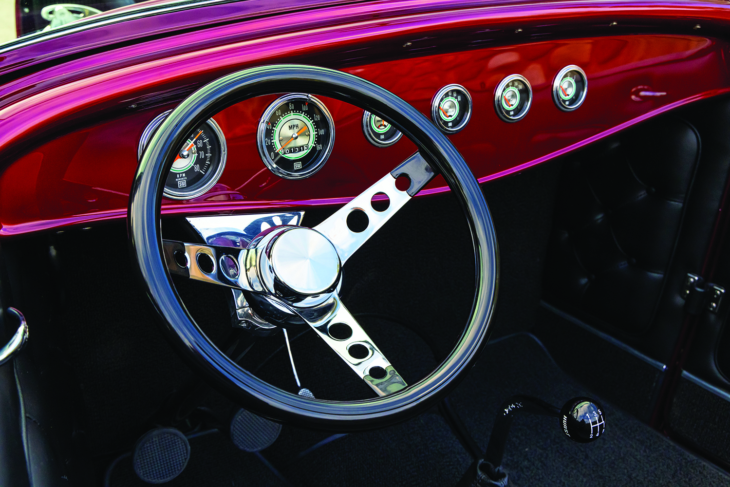 16 1932 Ford Roadster custom dashboard with chrome accented gauges and three spoke steering wheel